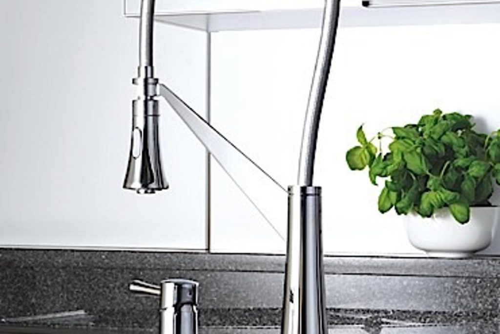 KAJA Soul Kitchen chrome mixer with a tall curved profile over a kitchen sink.