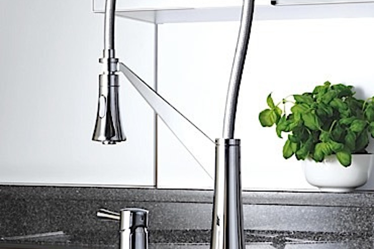 KAJA Soul Kitchen chrome mixer with a tall curved profile over a kitchen sink.