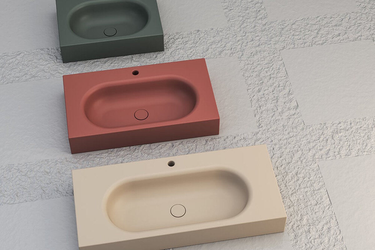 SDR Ceramiche washbasins in muted green, terracotta and cream.